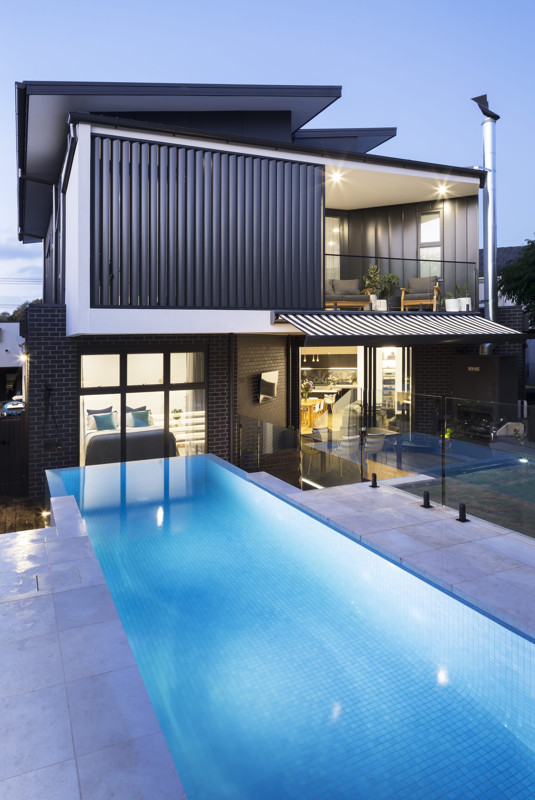 Kew architectural custom home by AGN Builders with standing seam Colorbond cladding and black brickwork