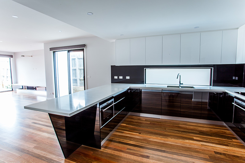 Family room with spotted gum timber flooring on the ground floor of the Mordialloc home